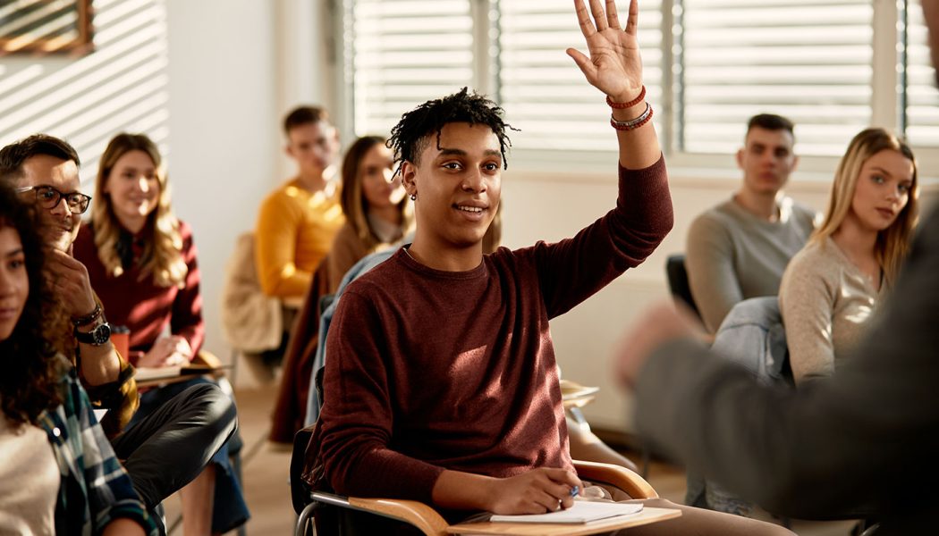 student-raising-hand-classroom-istock-1307457224